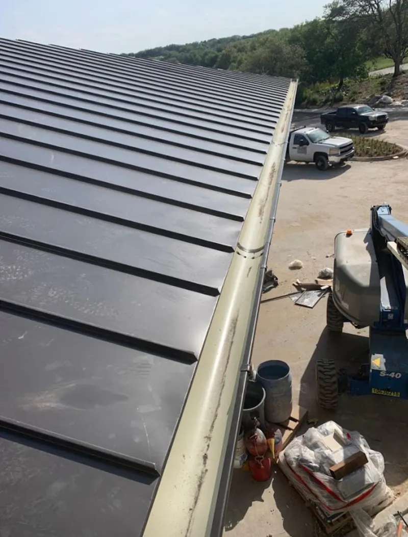 Standing seam panel and gutter detail on a metal roofing jobsite in Springettsbury
